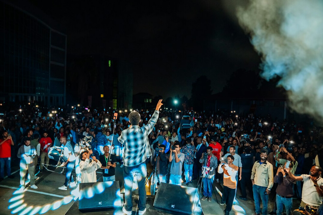 Crowd cheering at an outdoor concert