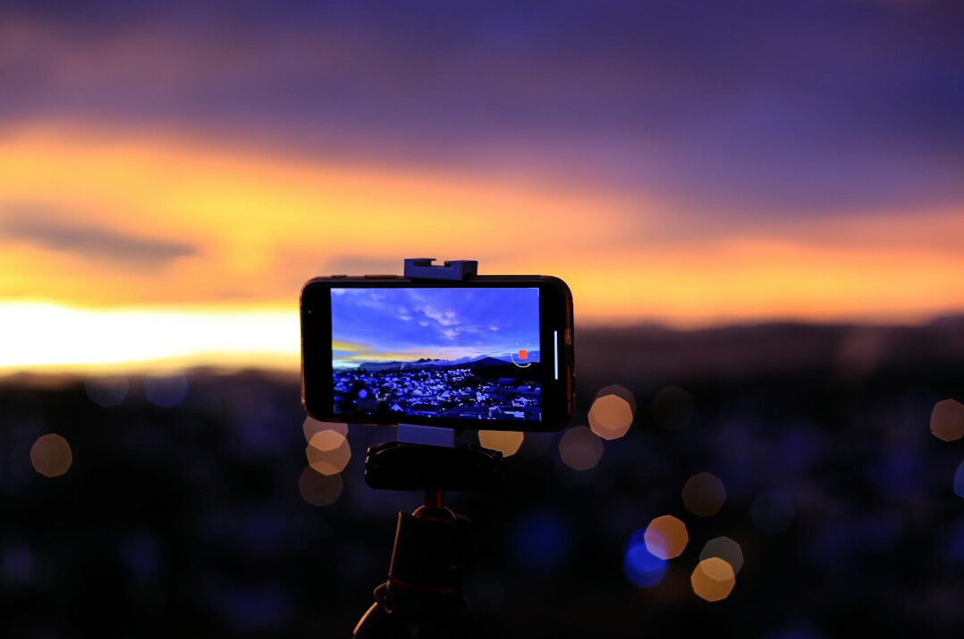 Smartphone on tripod recording content